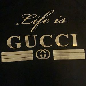 Medium sleeve black and gold “life is Gucci” shirt